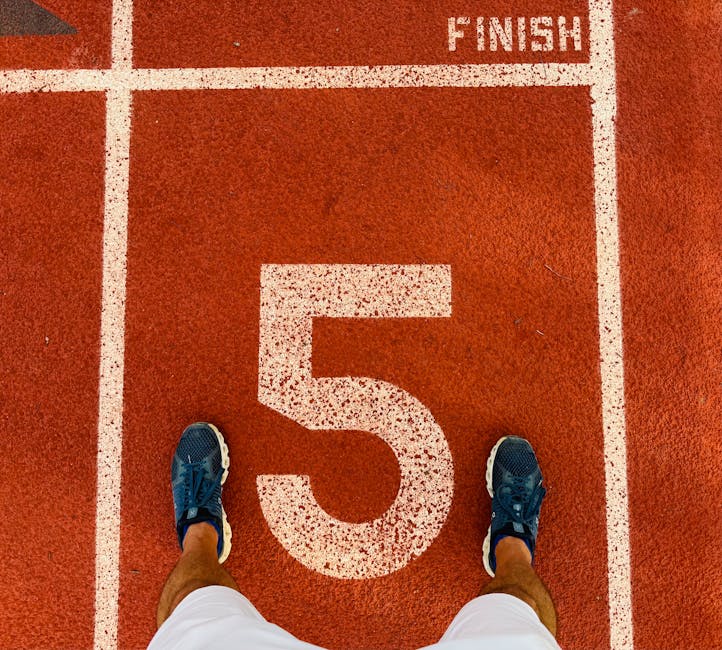 Runner's feet on track lane 5 at the finish line, symbolizing completion and success.